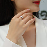 White gold vermeil three-stone emerald-cut moissanite engagement ring on hand