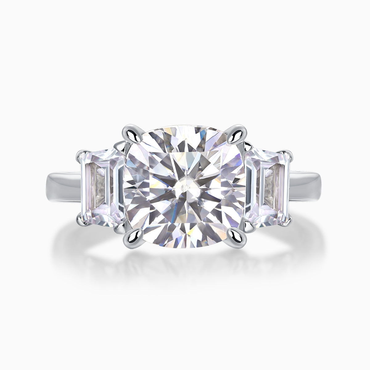 Three-stone cushion-cut moissanite ring with large center stone and side baguette stones