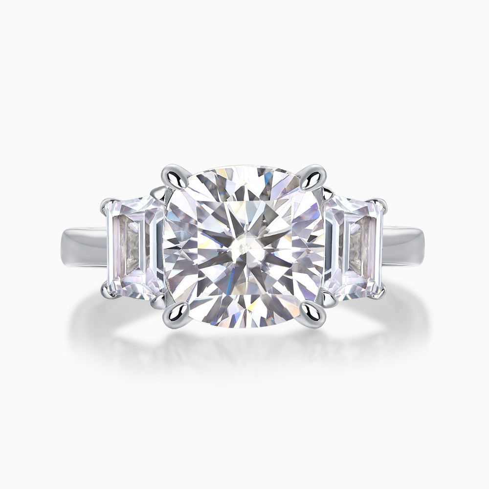 Three-stone cushion-cut moissanite ring with large center stone and side baguette stones