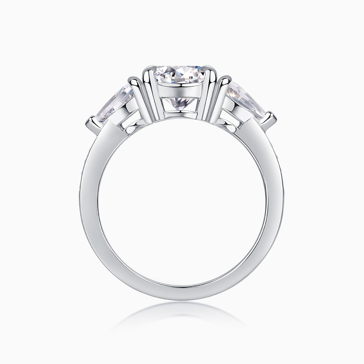 White gold-plated three-stone moissanite ring with prong-set round center stone