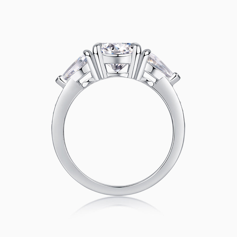 White gold-plated three-stone moissanite ring with prong-set round center stone