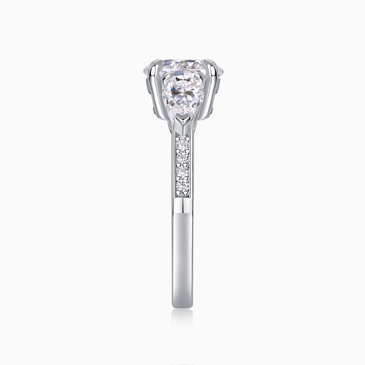 White gold-plated three-stone moissanite ring, prong-set round center stone with pavé shank