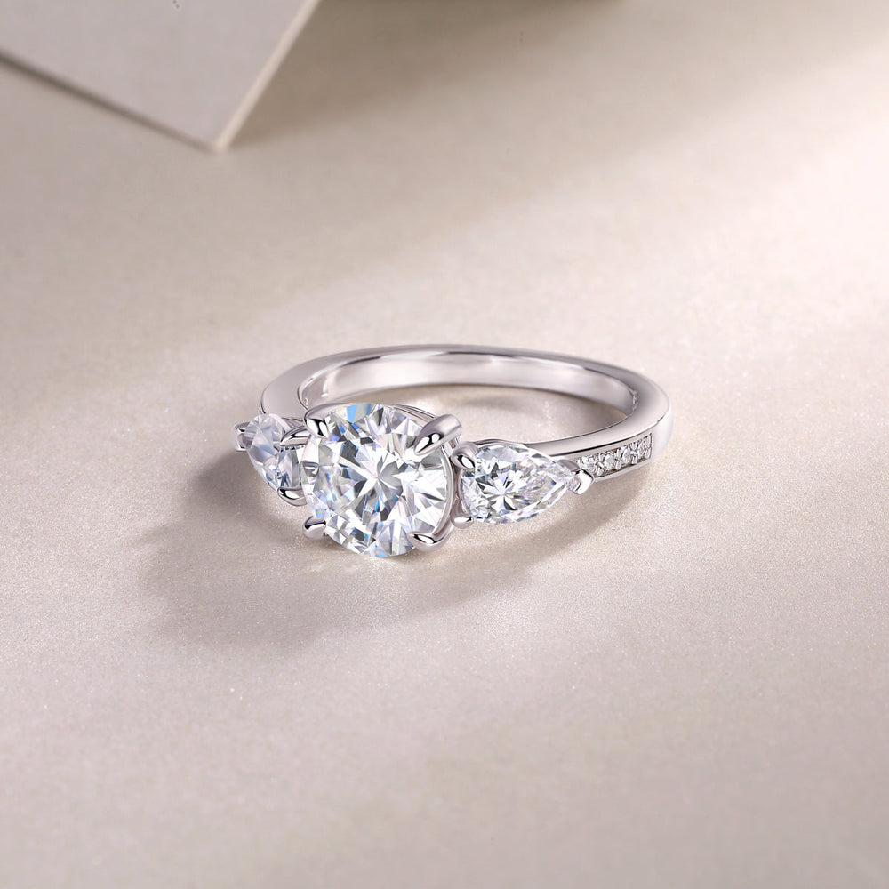 Three-stone moissanite ring, white gold-plated band with pavé detail on the shoulders