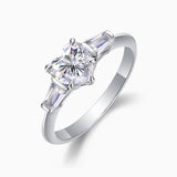 Three-stone heart-cut moissanite ring side view with baguette side stones and prong-set center
