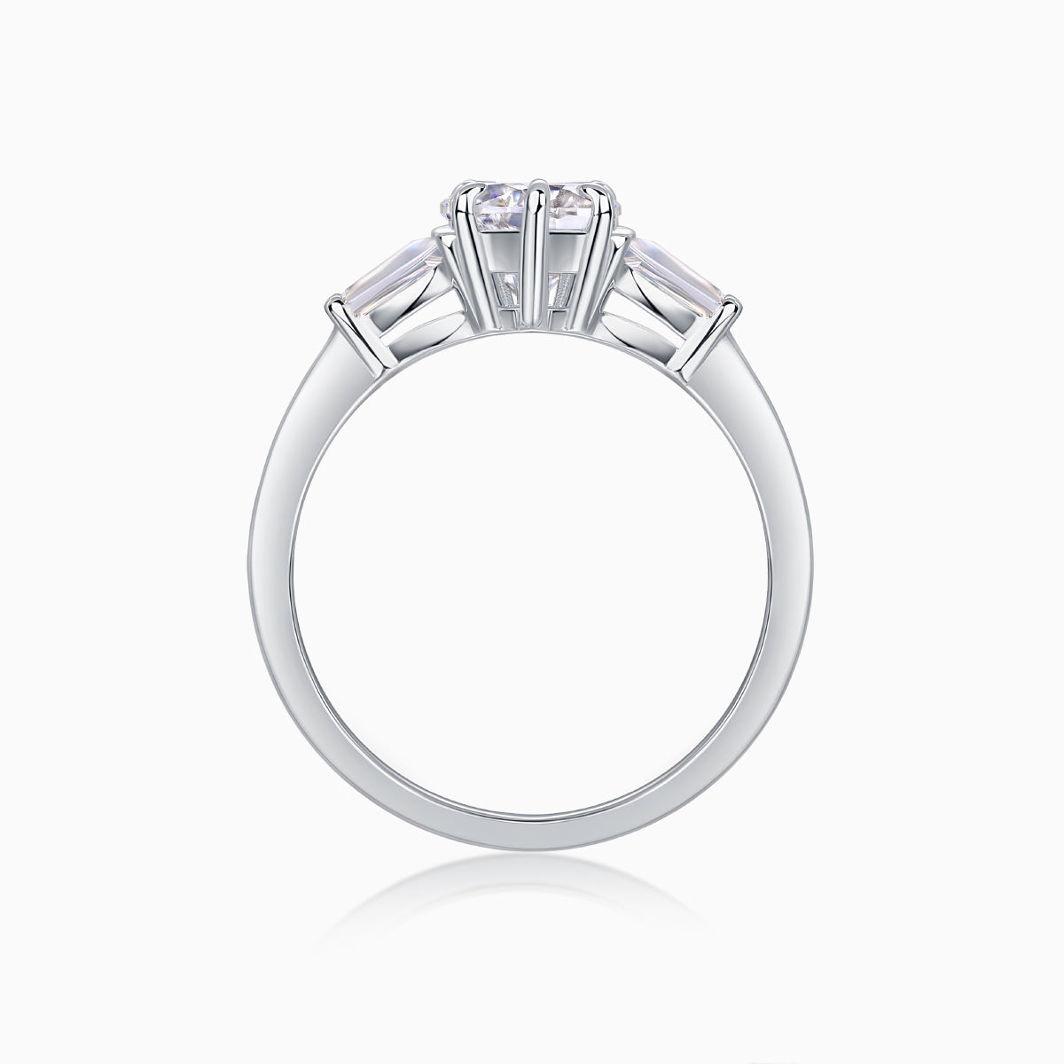 Three-stone moissanite ring top view from behind, prongs around heart-cut center stone