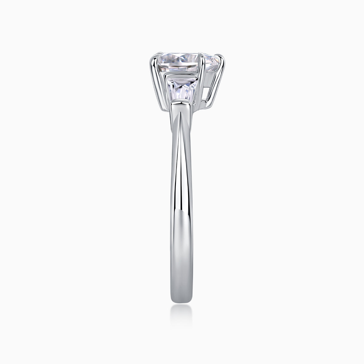 Three-stone moissanite ring profile with baguette side stones and tall prong-set heart-cut center