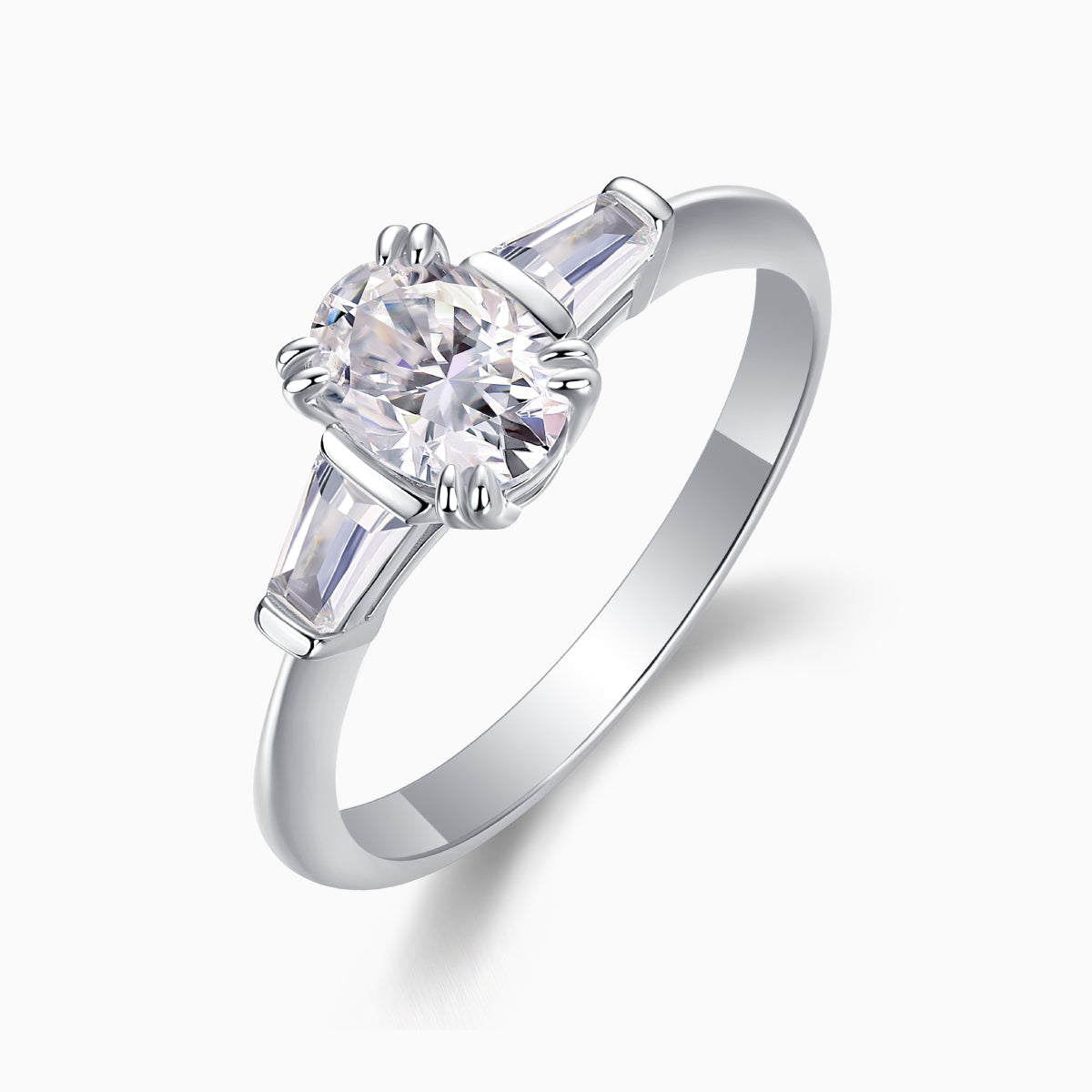 Angle view: oval center moissanite with baguette side stones, three-prong setting