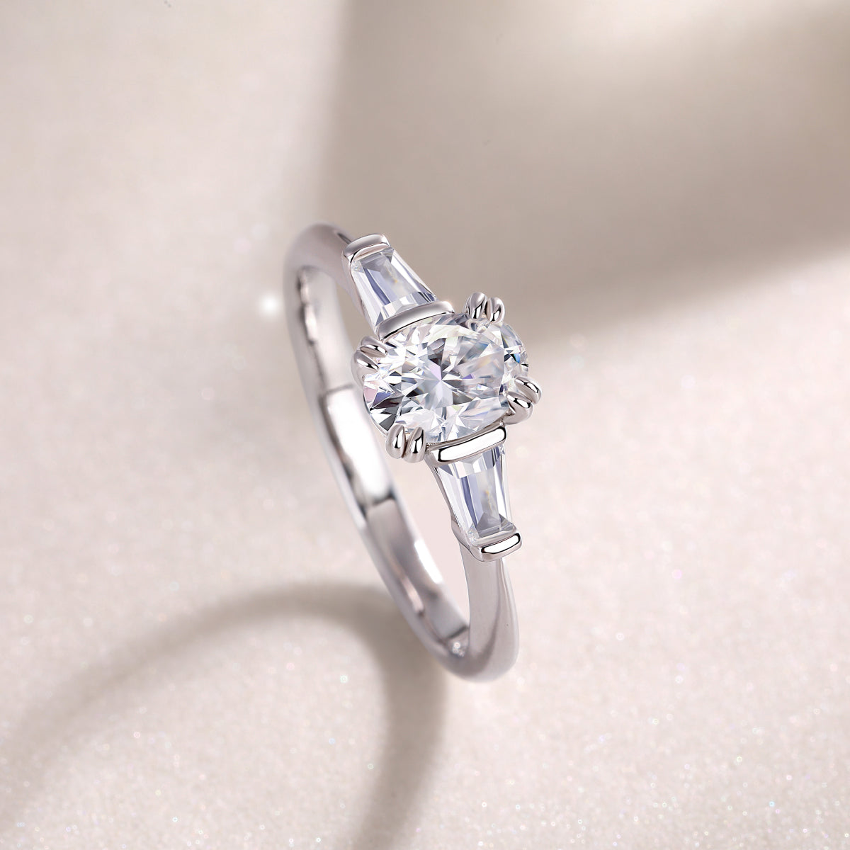 Side view: oval moissanite with baguette stones, white gold band and prongs