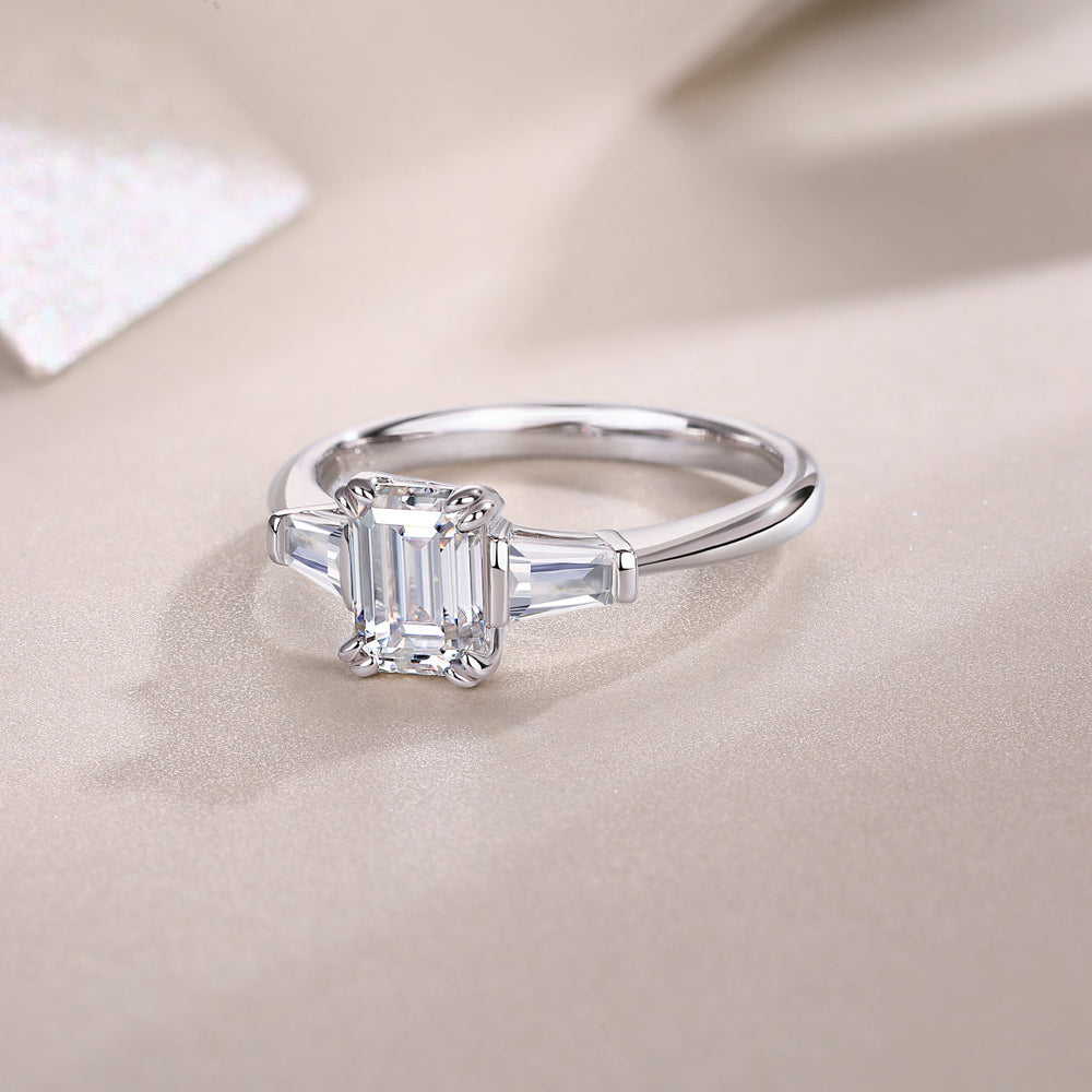 Three-stone emerald-cut moissanite engagement ring, white gold vermeil, side profile view
