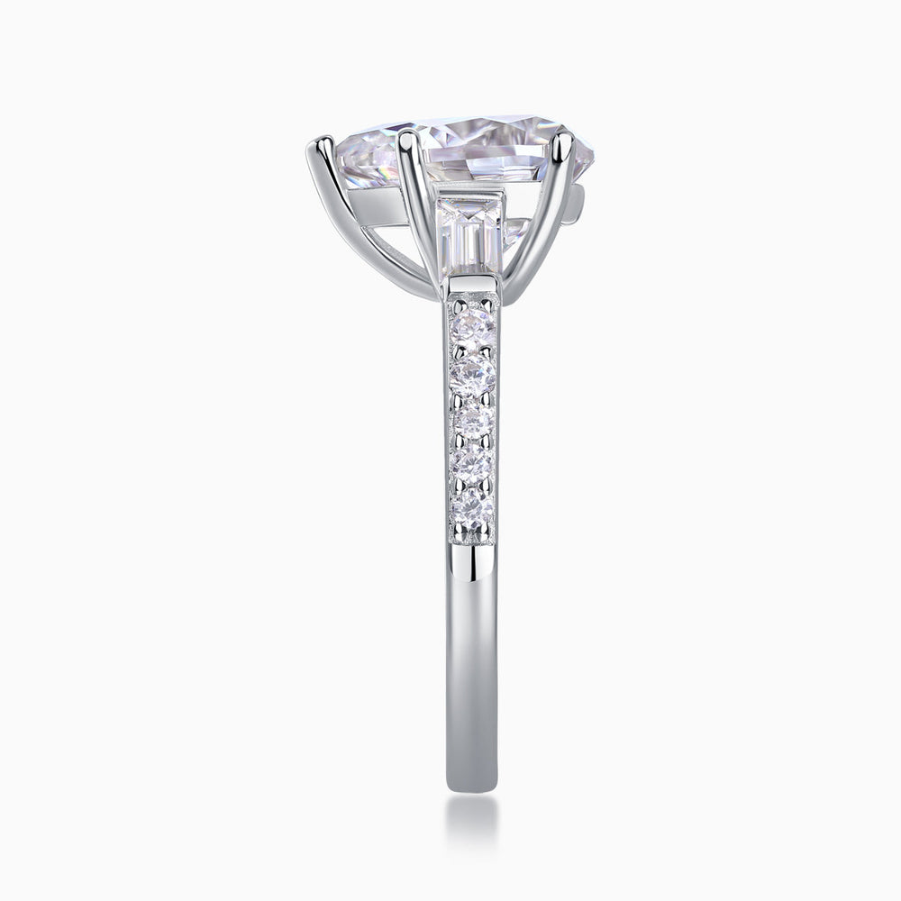 Vertical view: pear-cut moissanite engagement ring with baguette shoulders and pavé band