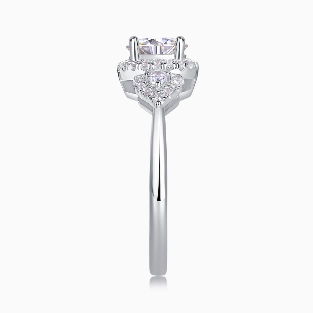 Moissanite halo engagement ring with round center stone, pavé halo, and prongs