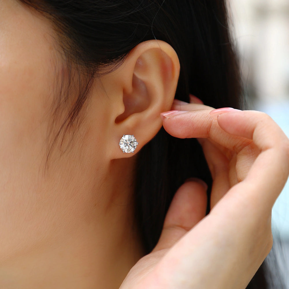Moissanite solitaire stud earrings worn on ear, round stone with 6 prongs