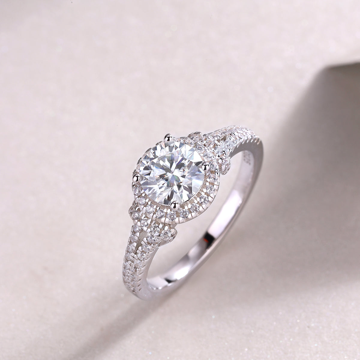 Round halo pavé engagement ring, close view of center stone and sparkling side pavé