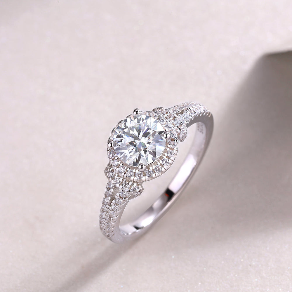 Round halo pavé engagement ring, close view of center stone and sparkling side pavé