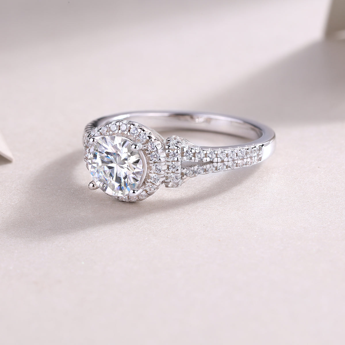 Round moissanite halo engagement ring, pavé band with center stone in bezel-style halo