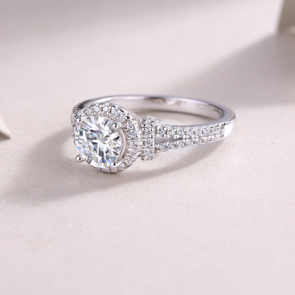 Round moissanite halo engagement ring, pavé band with center stone in bezel-style halo