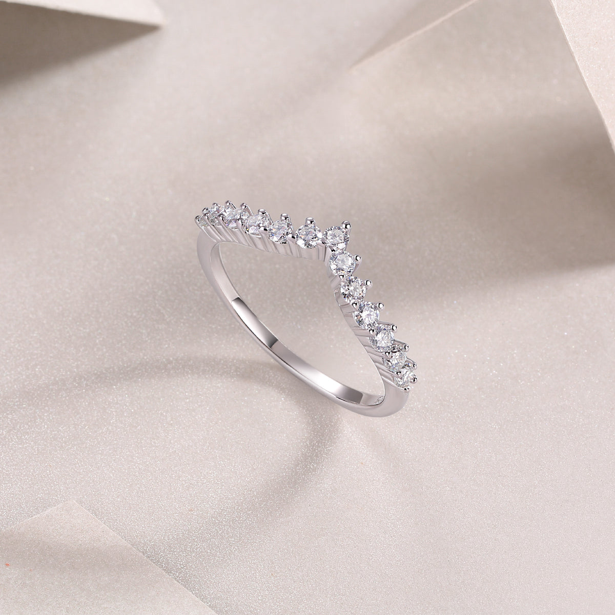 Curved Moissanite Pavé Band, angled view of arched band with continuous pavé stone row