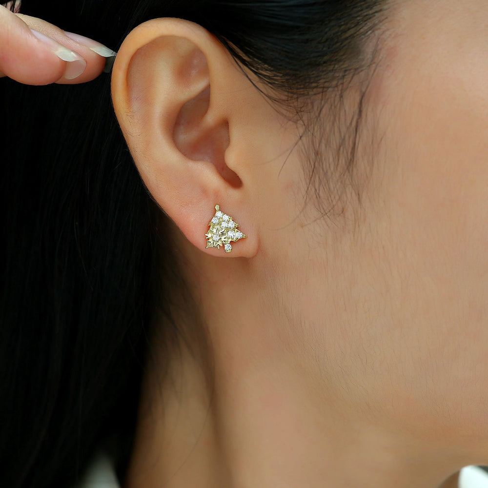 Christmas tree stud earrings on ear, white gold vermeil with round moissanite stones
