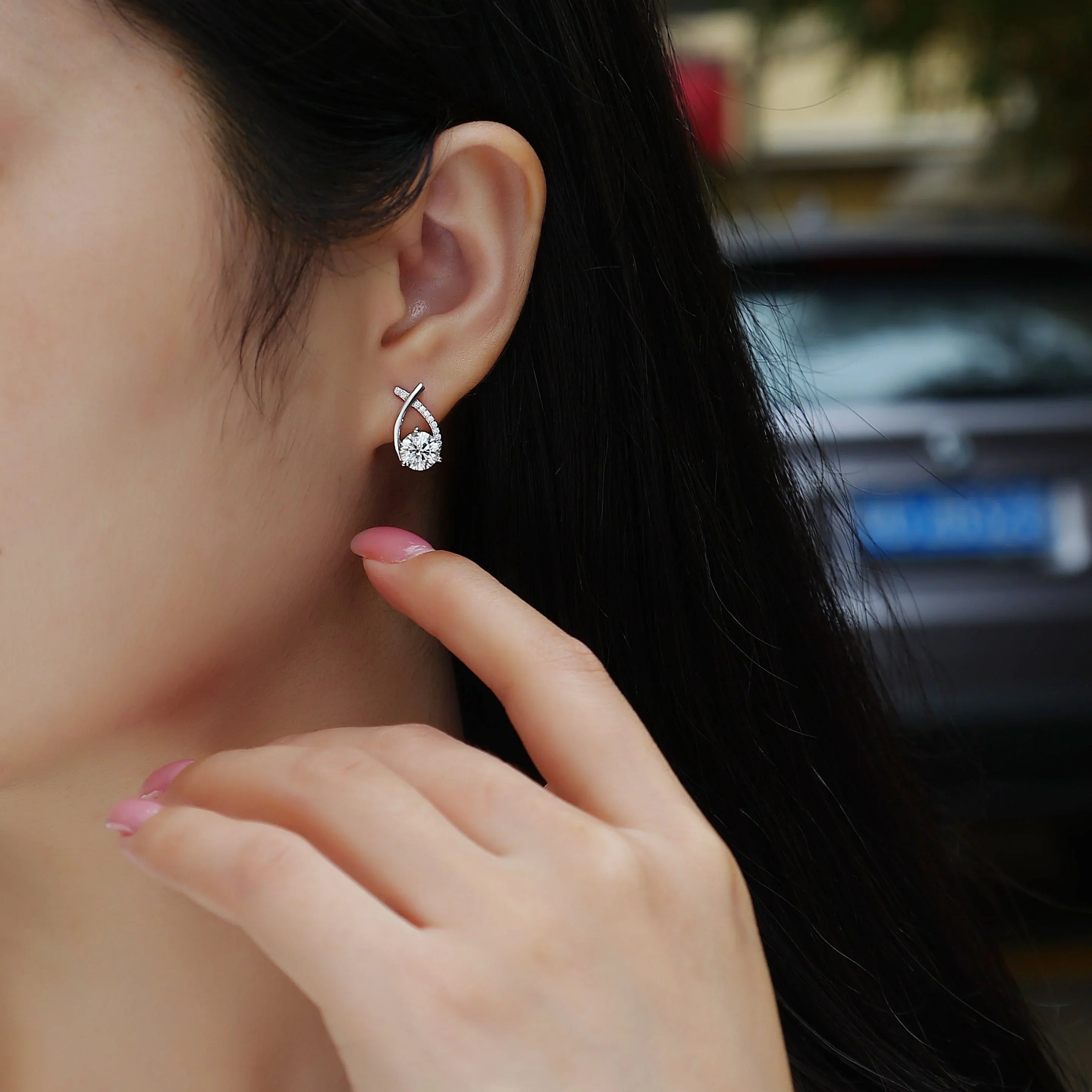 Worn stud earrings: teardrop moissanite with ribbon pavé, white gold vermeil finish