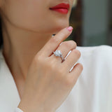 Moissanite halo engagement ring on finger; pavé twist split shank