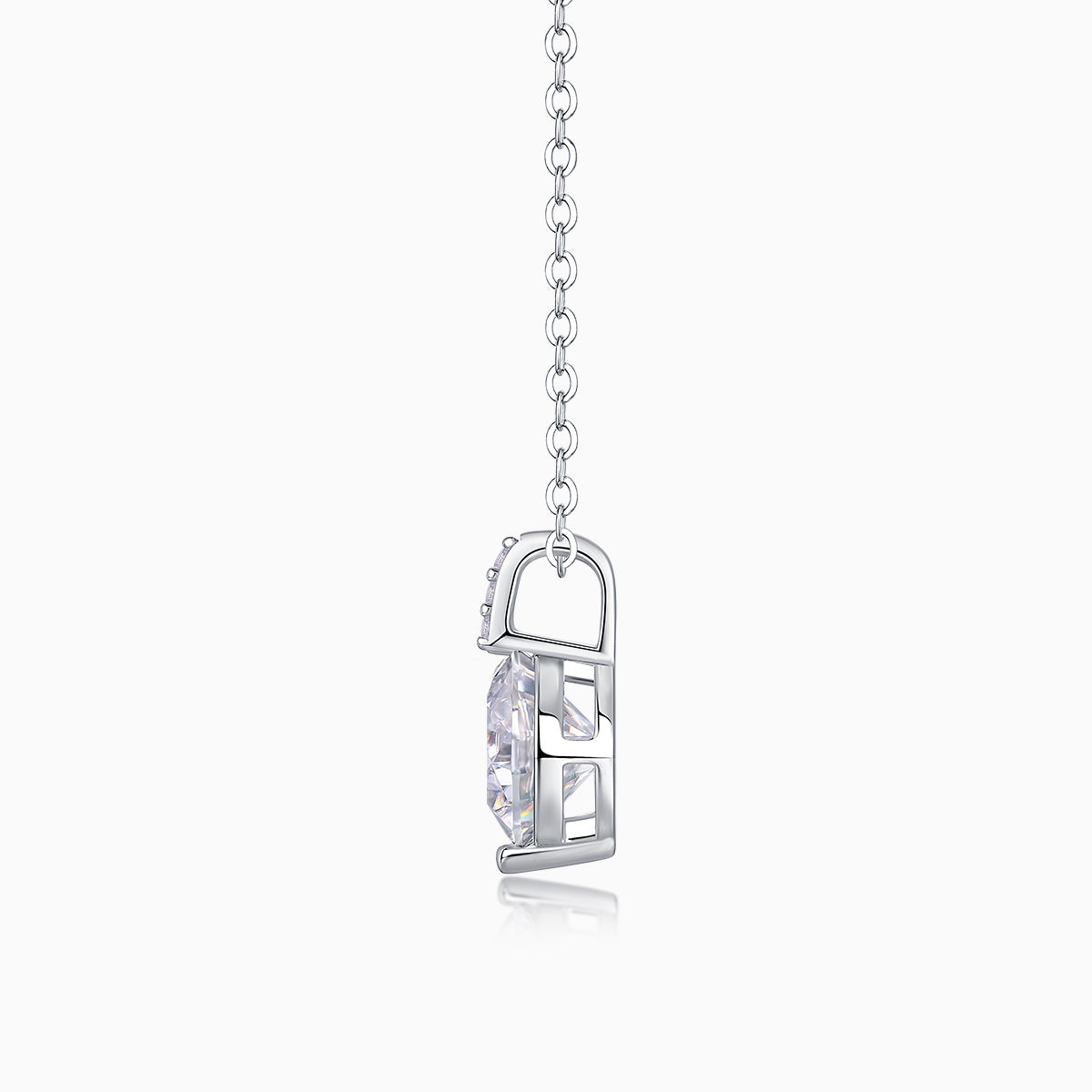 Side view of round moissanite solitaire in open bezel, white gold vermeil