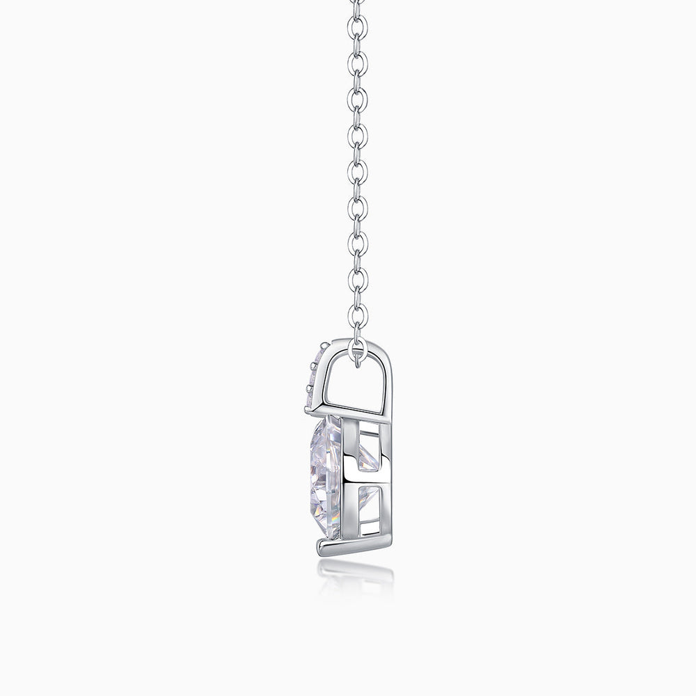 Side view of round moissanite solitaire in open bezel, white gold vermeil