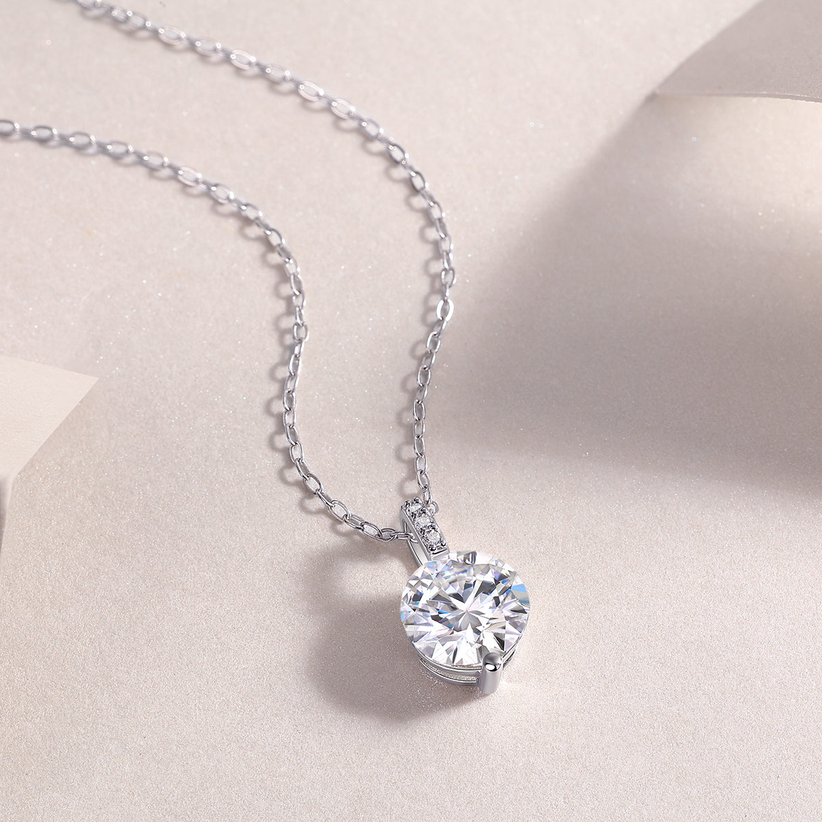 Close-up: round moissanite solitaire pendant on white gold vermeil chain