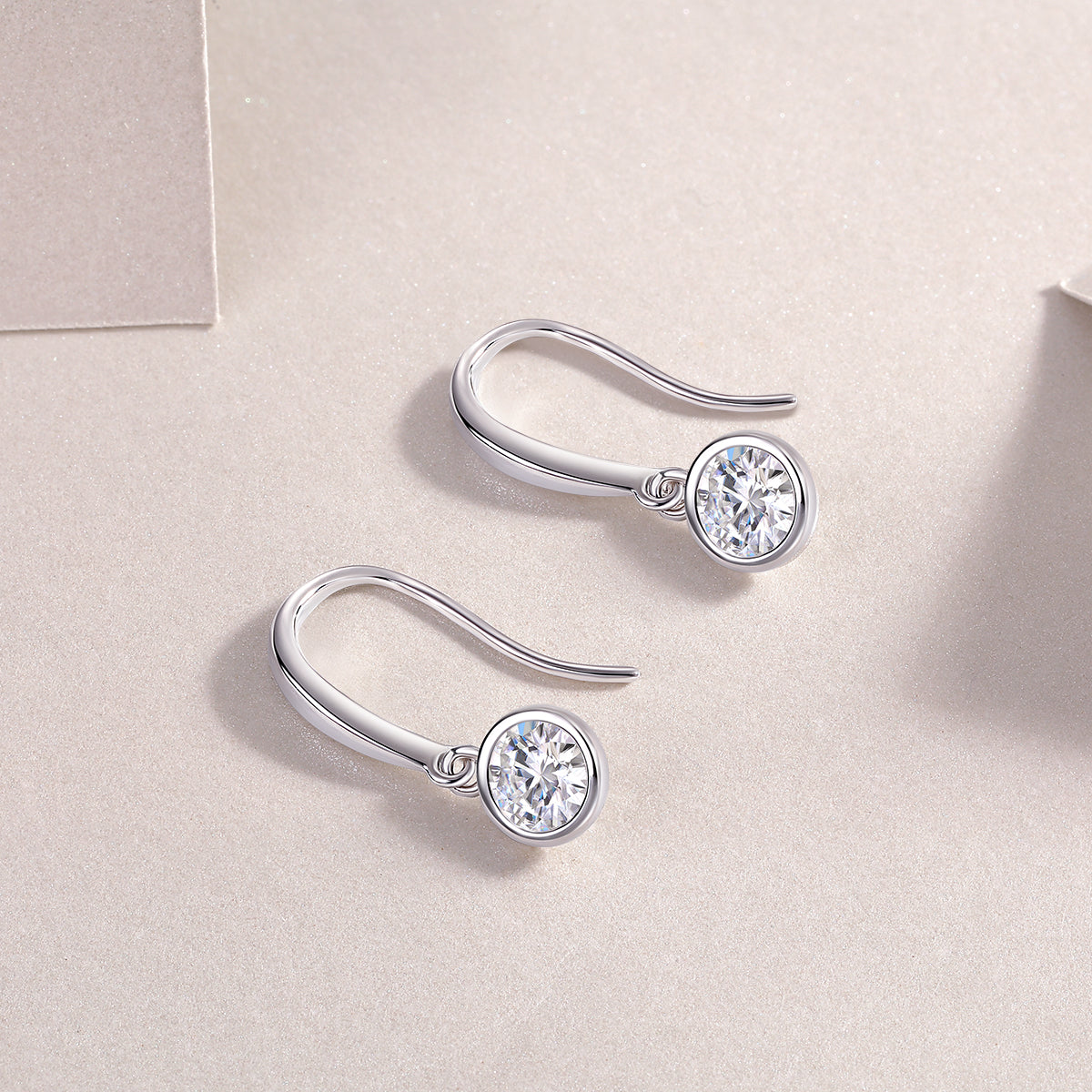 Moissanite solitaire drop earrings, round bezel stones on hook settings