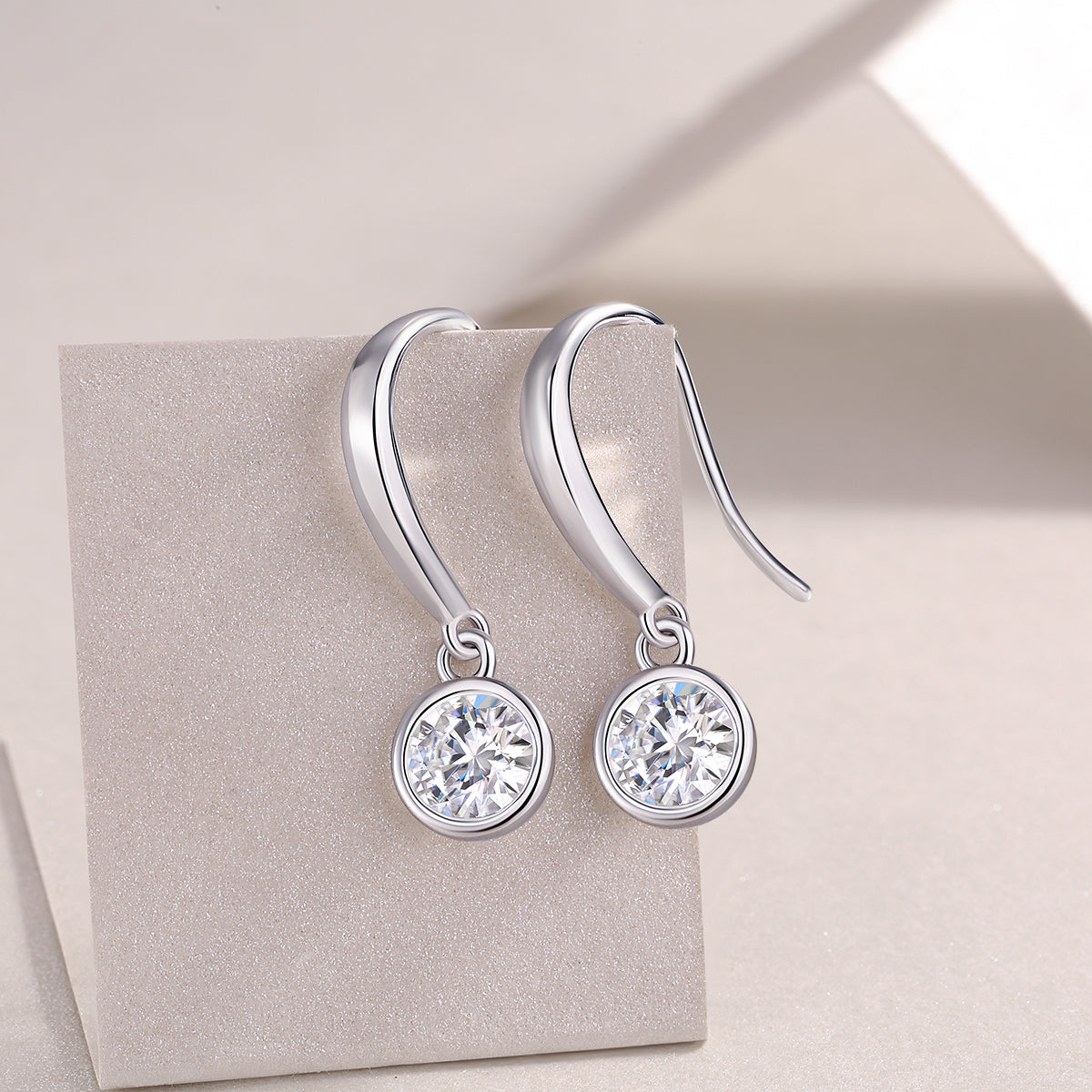 Round moissanite drop earrings, bezel-set stones with small loop details
