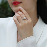 Ring on finger: oval halo moissanite with double pavé band, white gold vermeil