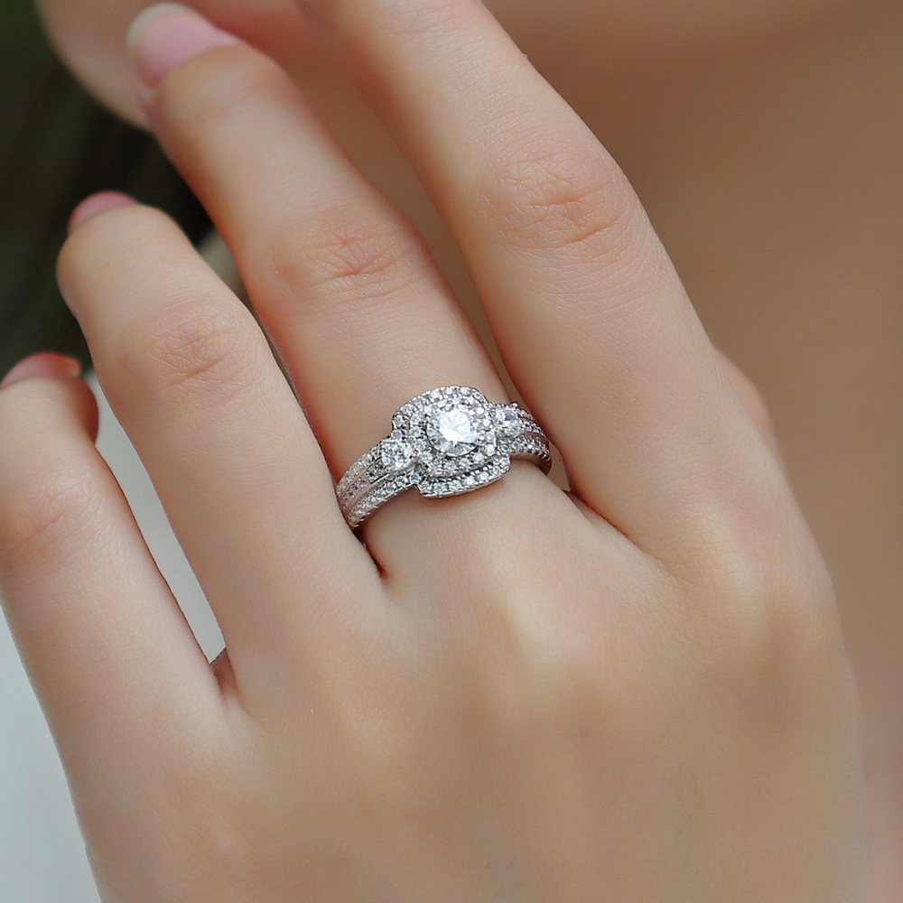 Square halo moissanite ring with pavé band, worn on finger
