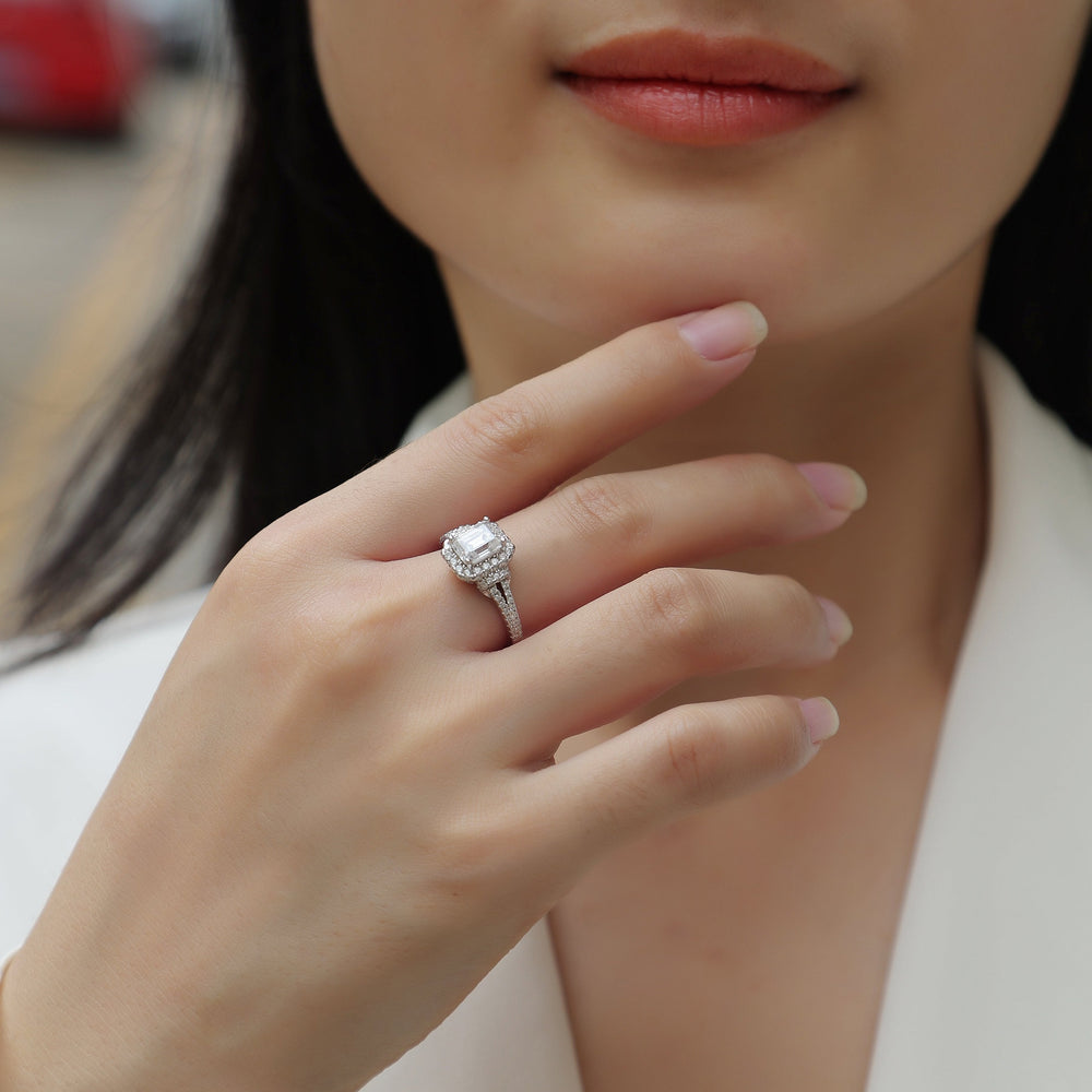 Emerald-cut halo ring on hand, double pavé split shank, white gold vermeil
