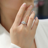 Hand wearing round halo art deco cross pavé ring with sparkling round center stone
