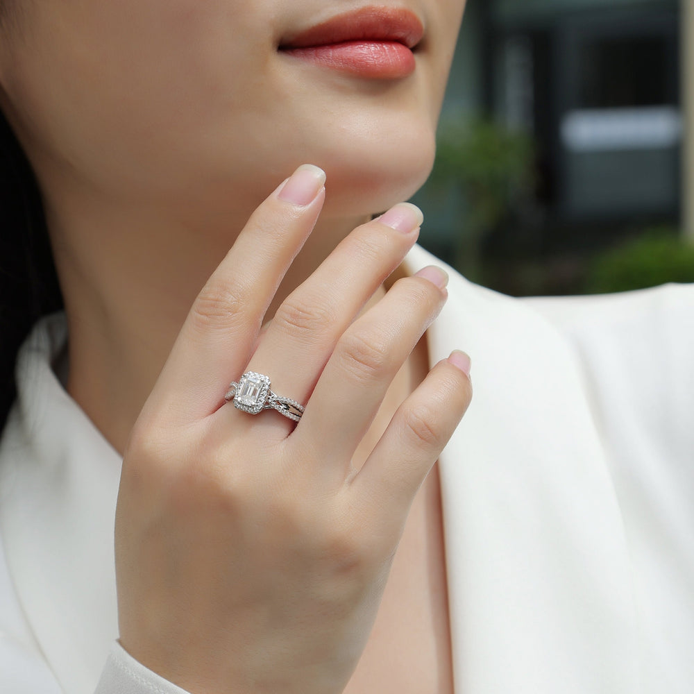 Ring on hand: emerald-cut halo moissanite with twisted pavé band, white gold tone
