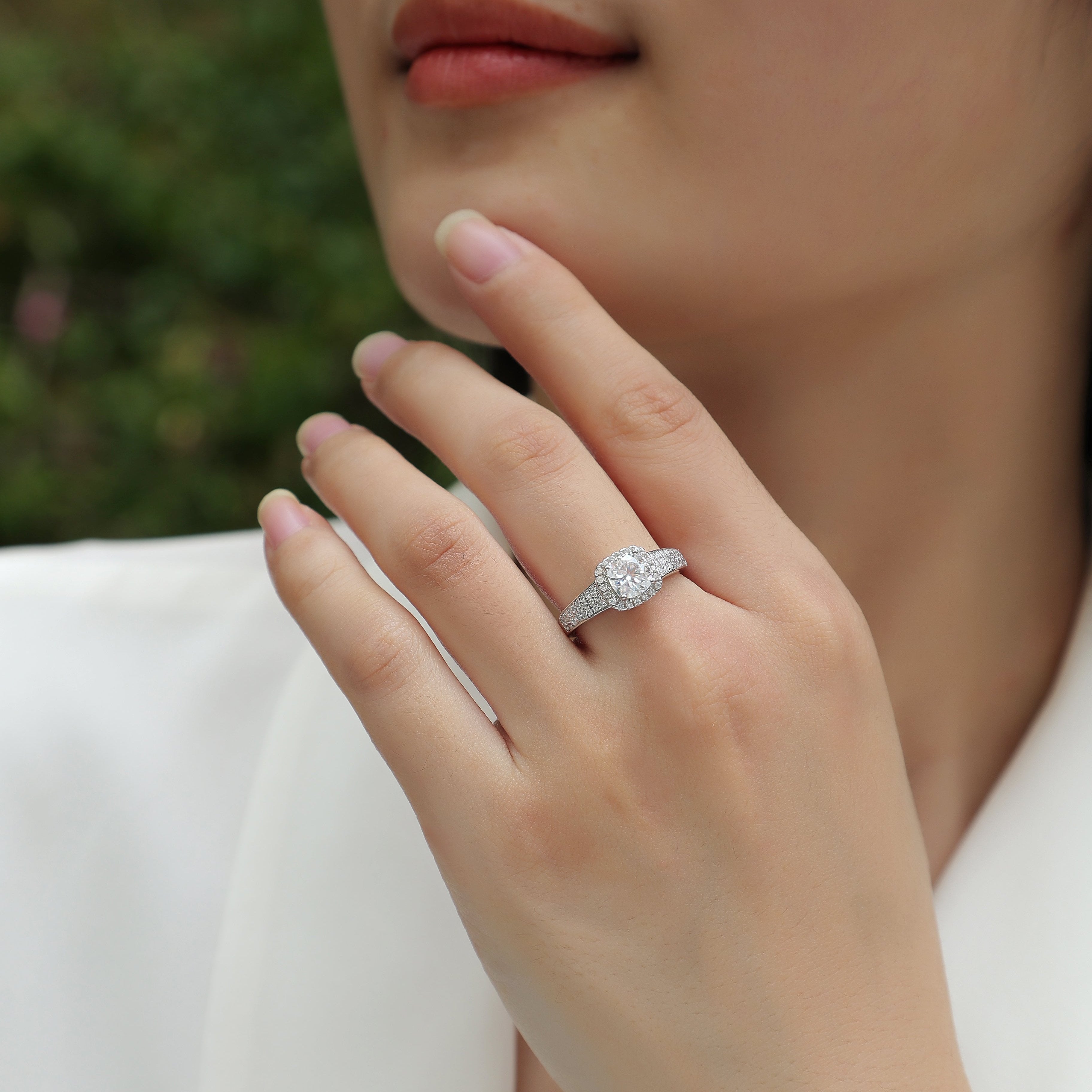 Moissanite cushion halo ring on hand, triple pavé split shank in white gold vermeil