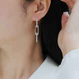 Pavé bar paperclip drop earring with oval link detail, close-up on earlobe