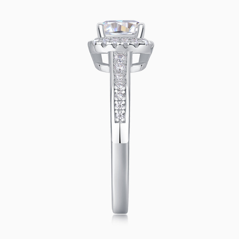 Front view of cushion-cut moissanite in halo, pavé-set band and prongs
