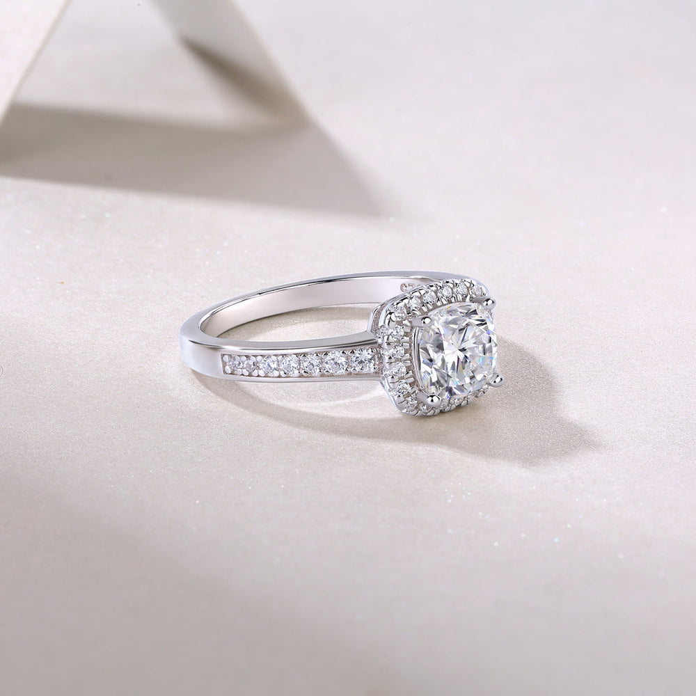Side profile of cushion halo pavé moissanite engagement ring with pavé-lined band