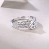 Side view of round halo moissanite ring with pavé split shank, white gold vermeil