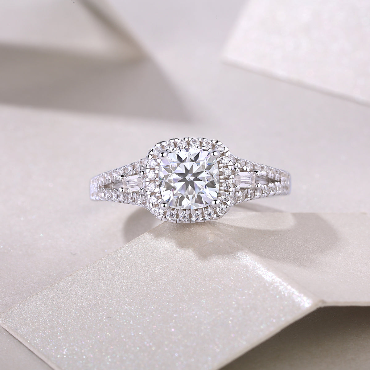 Cushion cut halo moissanite ring with baguette accents and pavé details, white gold