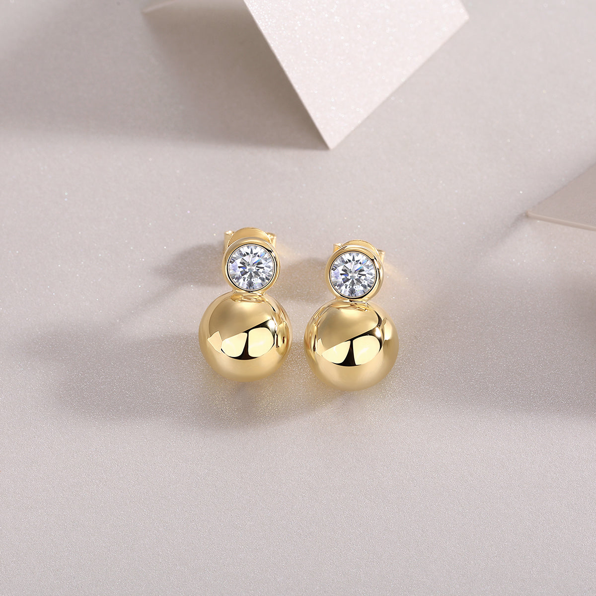 Gold vermeil bezel moissanite ball stud earrings with round stone and polished sphere