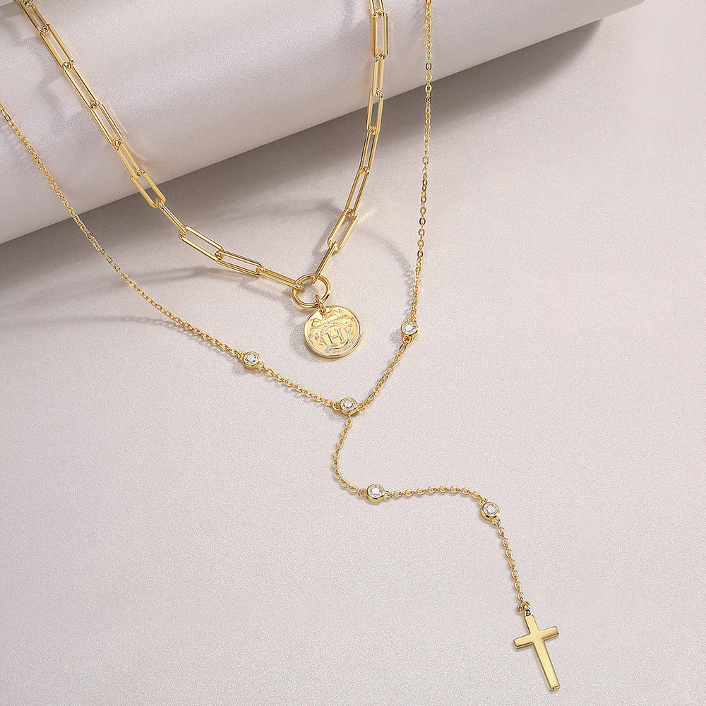 Layered lariat necklace with round coin medallion, blue moissanite accents, cross