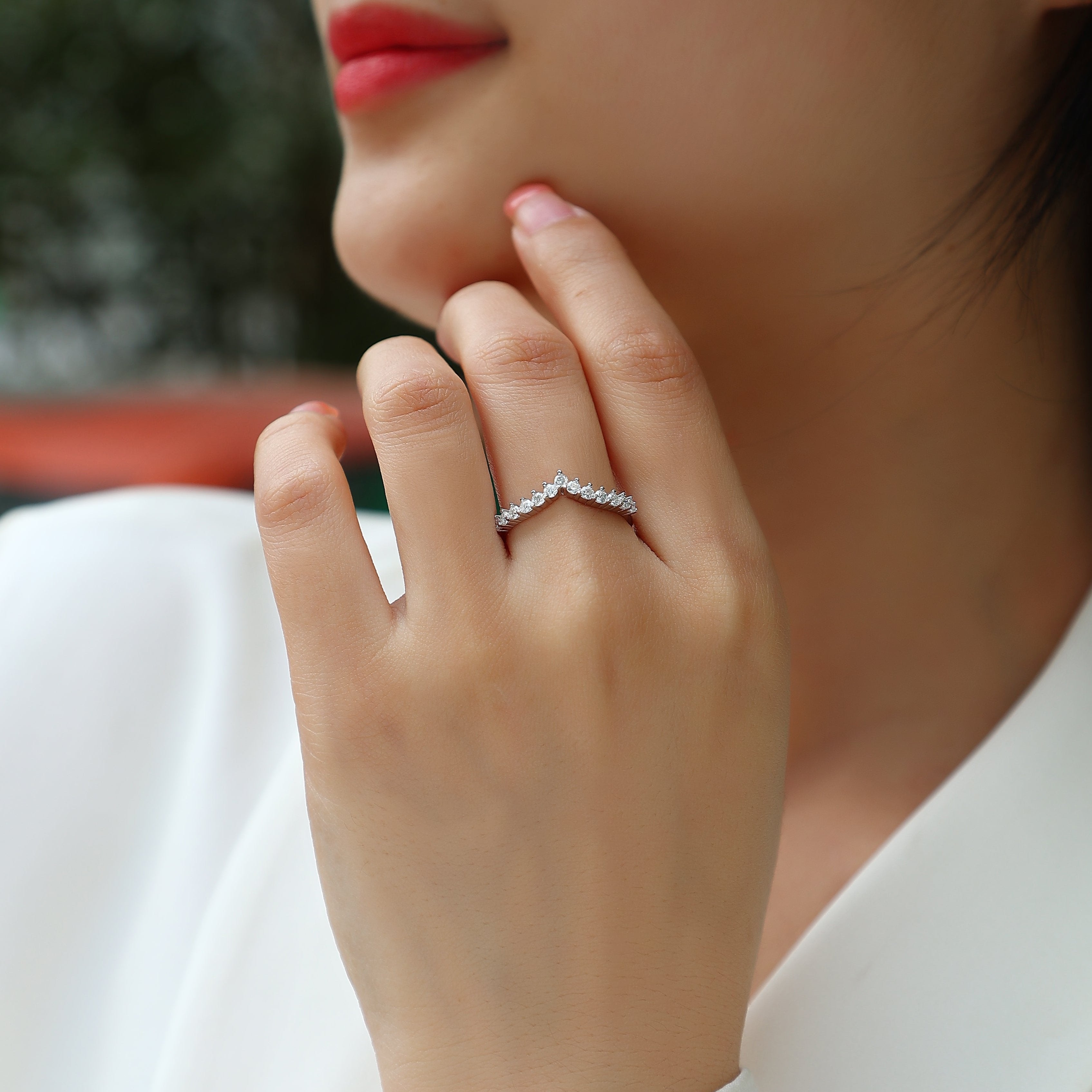 Curved Moissanite Pavé Band on finger, white gold vermeil with bright round pavé stones