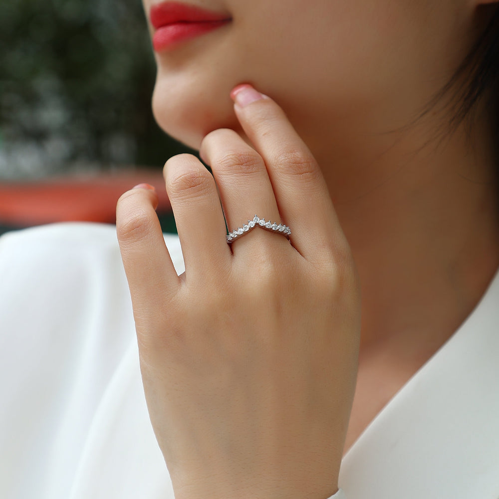 Curved Moissanite Pavé Band on finger, white gold vermeil with bright round pavé stones