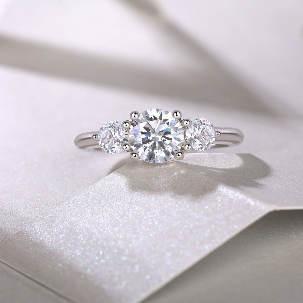 Three round moissanite stones on a white gold vermeil band, center stone with two side stones