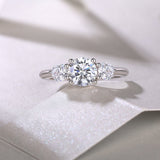 Three round moissanite stones on a white gold vermeil band, center stone with two side stones