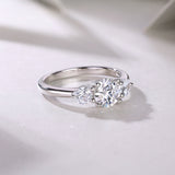 Side view of round three-stone moissanite engagement ring, white gold vermeil