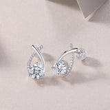Teardrop moissanite stud earrings with curved ribbon pavé and round center stones