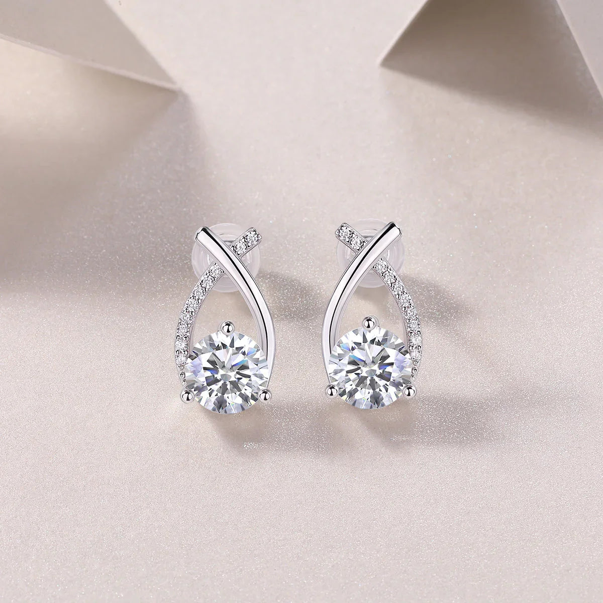 Teardrop ribbon pavé moissanite studs with bezel-set center stone and push-back
