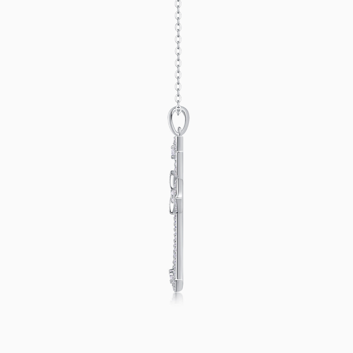 White gold tone cross pendant back view with bail and chain links, pavé details
